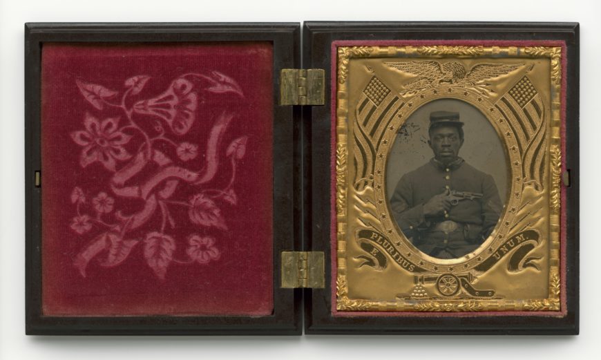 Hand-colored tintype with cover glass of an unknown Black U.S. soldier, in black thermoplastic case with brass hinges and red velvet liner, c. 1861–65 (Smithsonian National Museum of African American History and Culture, Washington, D.C.)
