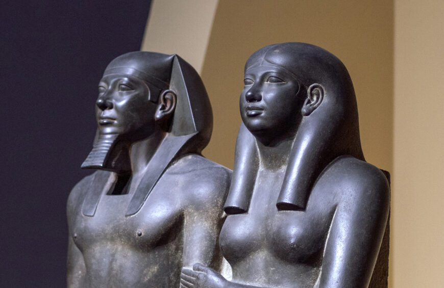 King Menkaura (Mycerinus) and queen (Old Kingdom, Dynasty 4), 2490–2472 B.C.E. (Menkaura Valley Temple, Giza, Egypt), greywacke, 142.2 x 57.1 x 55.2 cm, 676.8 kg (Museum of Fine Arts, Boston)